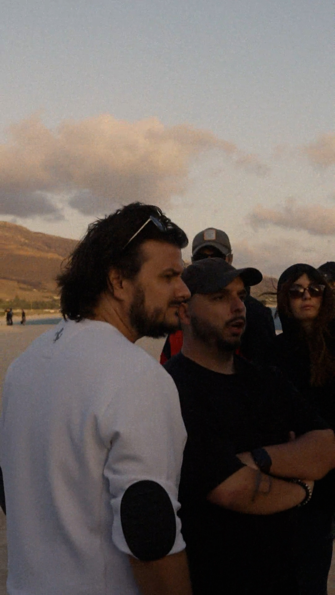 The crew watching playback at dusk
